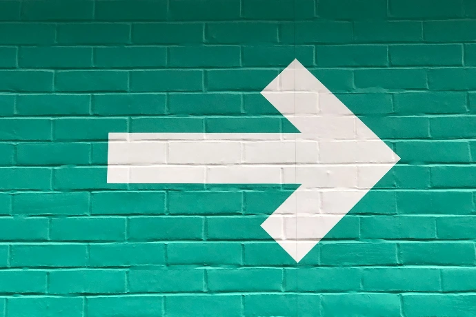 selective focus photography of white arrow signage