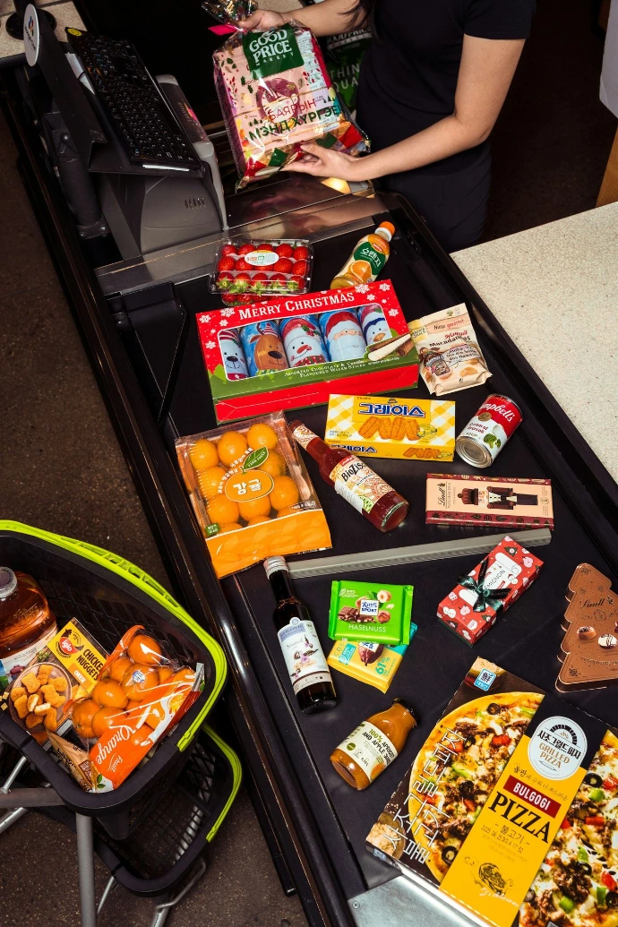 Groceries are laid out on a checkout conveyor belt.